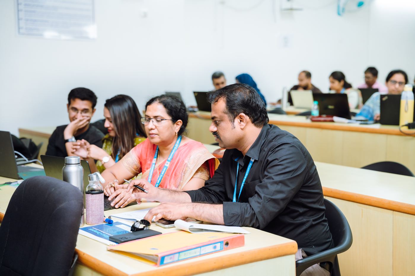 Faculty working in teams during an FDP session